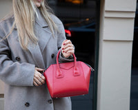 Elegant small leather handbag with a structured design, featuring top handles and an adjustable shoulder strap for
versatile carrying. This genuine leather bag offers a spacious interior with secure zipper closure and interior pockets. A
stylish everyday handbag perfect for work, outings, and daily essentials.